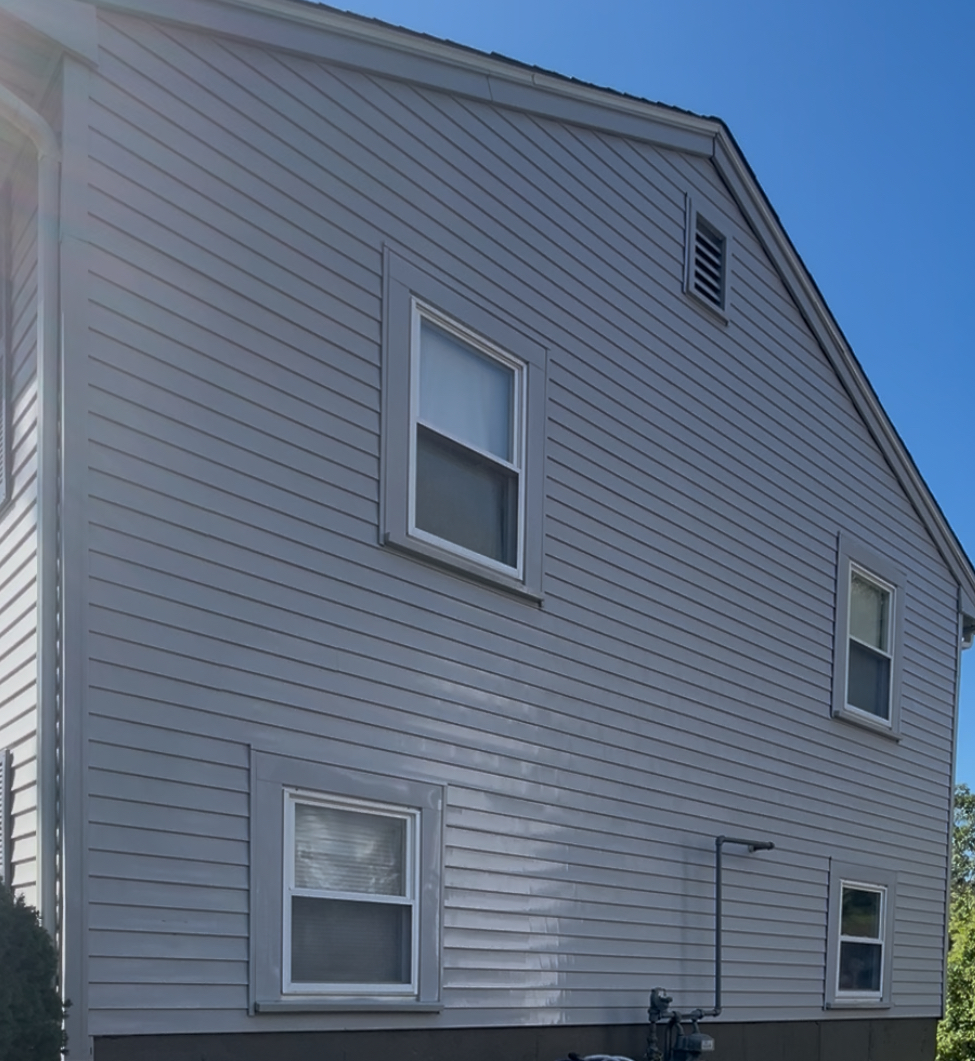 After full exterior house wash by H2WOAH Exterior Cleaning showing clean bright siding