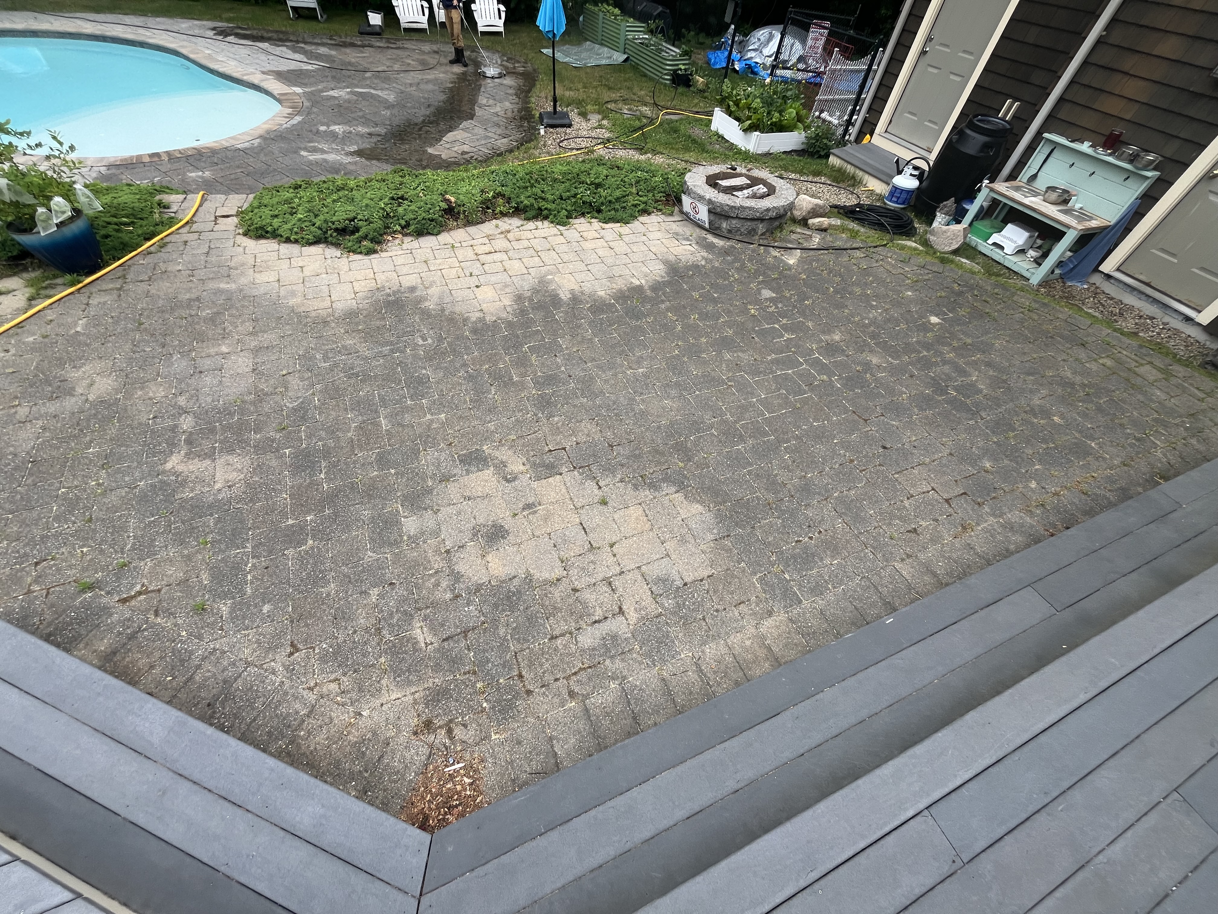 Paver patio before cleaning in Scituate, MA — dirty brick pavers stained with algae, dirt, and grime