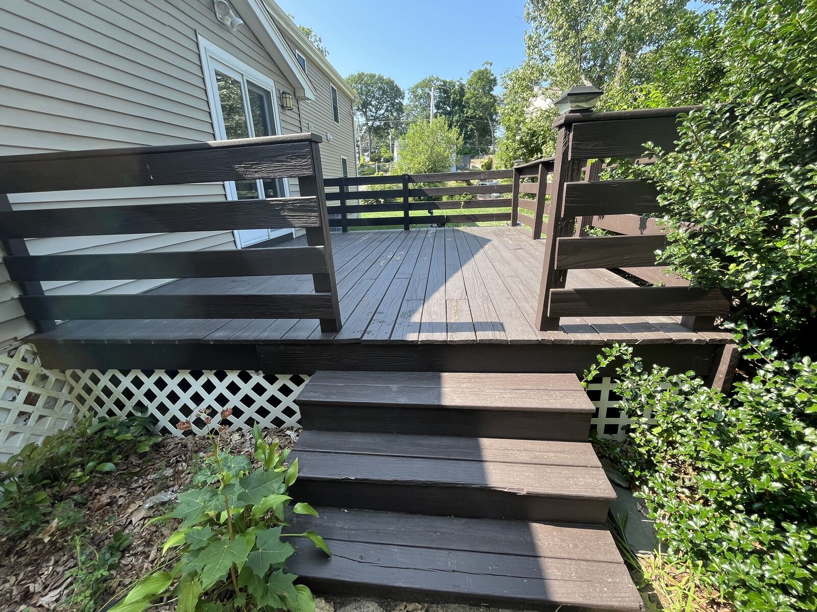After dark wood deck cleaning in Marshfield MA by H2WOAH Exterior Cleaning showing a refreshed deck