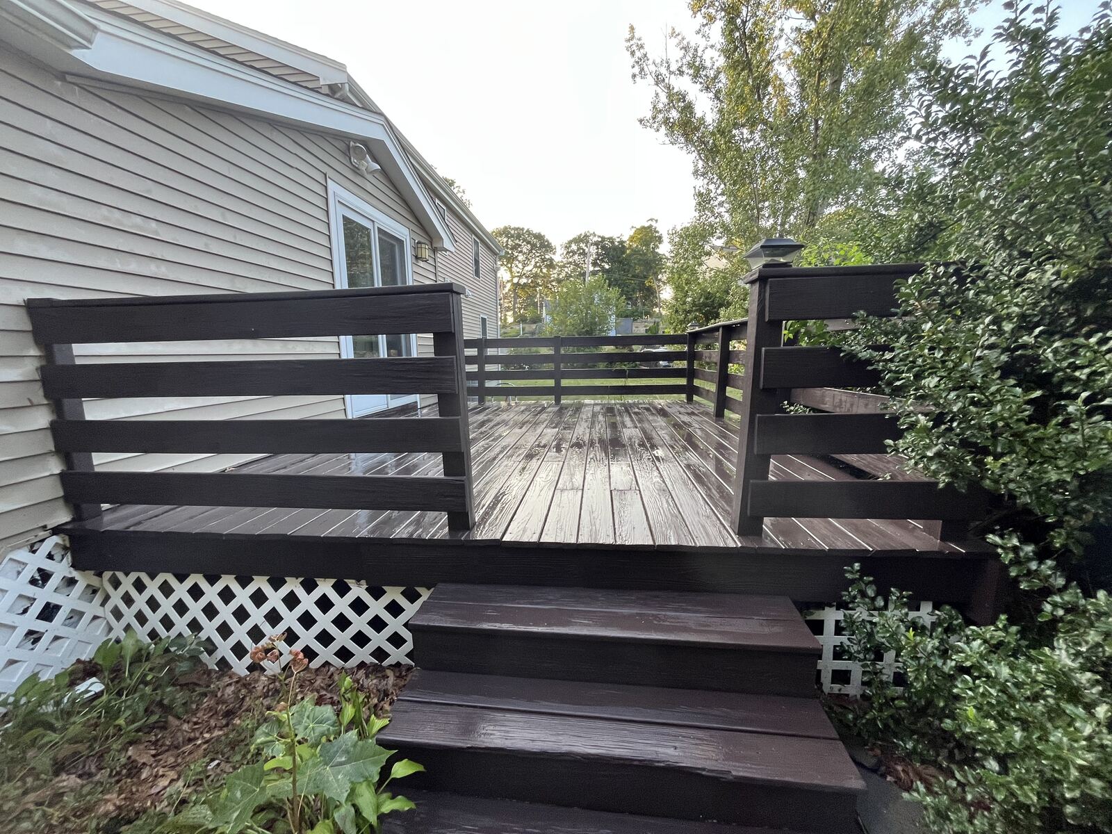 Before dark wood deck cleaning in Marshfield MA showing weathering and grime on deck boards and stairs