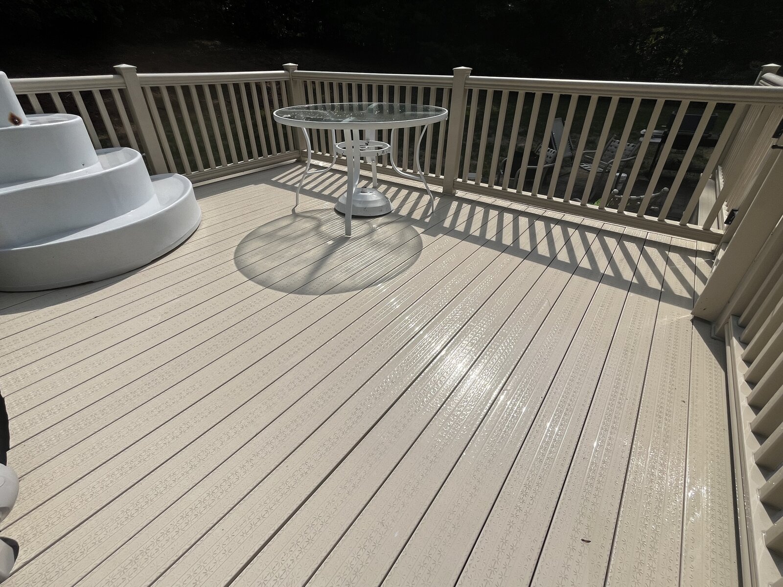 After pressure washing a composite pool deck in Marshfield MA showing clean, bright deck boards with the shine restored around the pool
