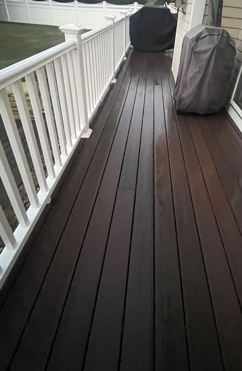After composite deck washing in Weymouth MA by H2WOAH Exterior Cleaning showing restored dark brown finish