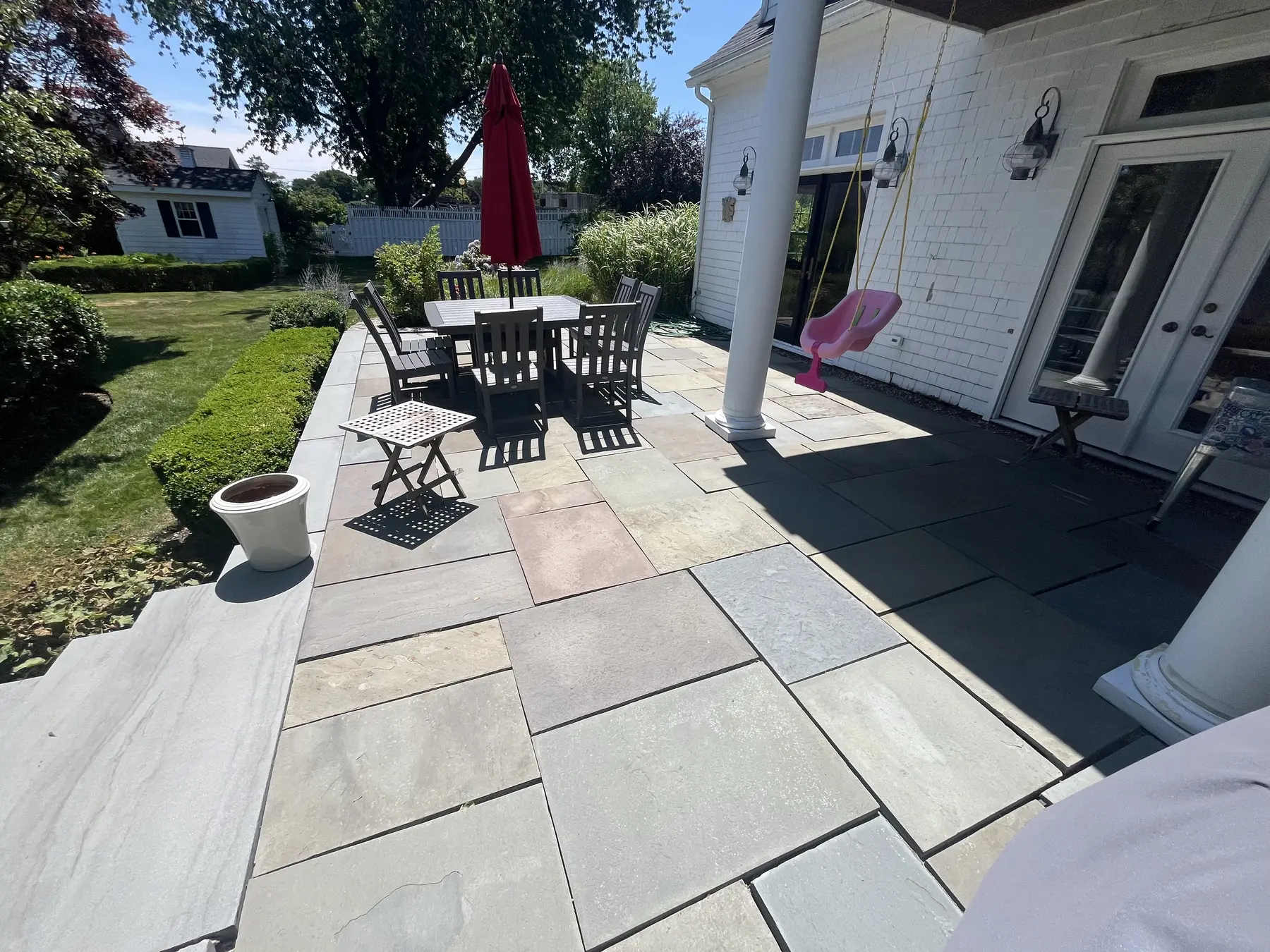 Bluestone patio cleaning in Plymouth MA, clean natural stone colors restored after exterior cleaning by H2WOAH