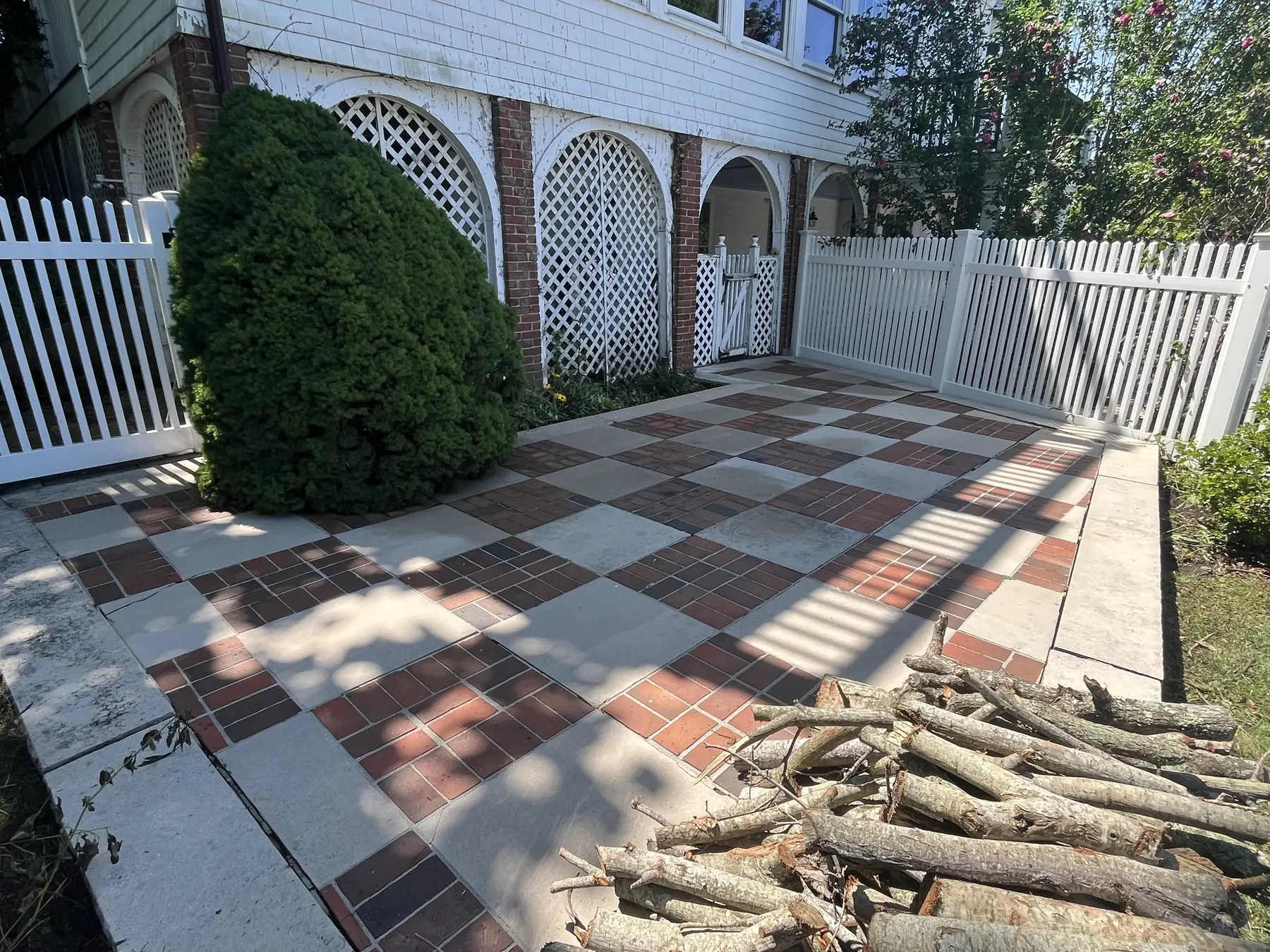 Brick patio cleaning in Plymouth MA, clean brick and stone checkerboard patio after soft washing and pressure washing