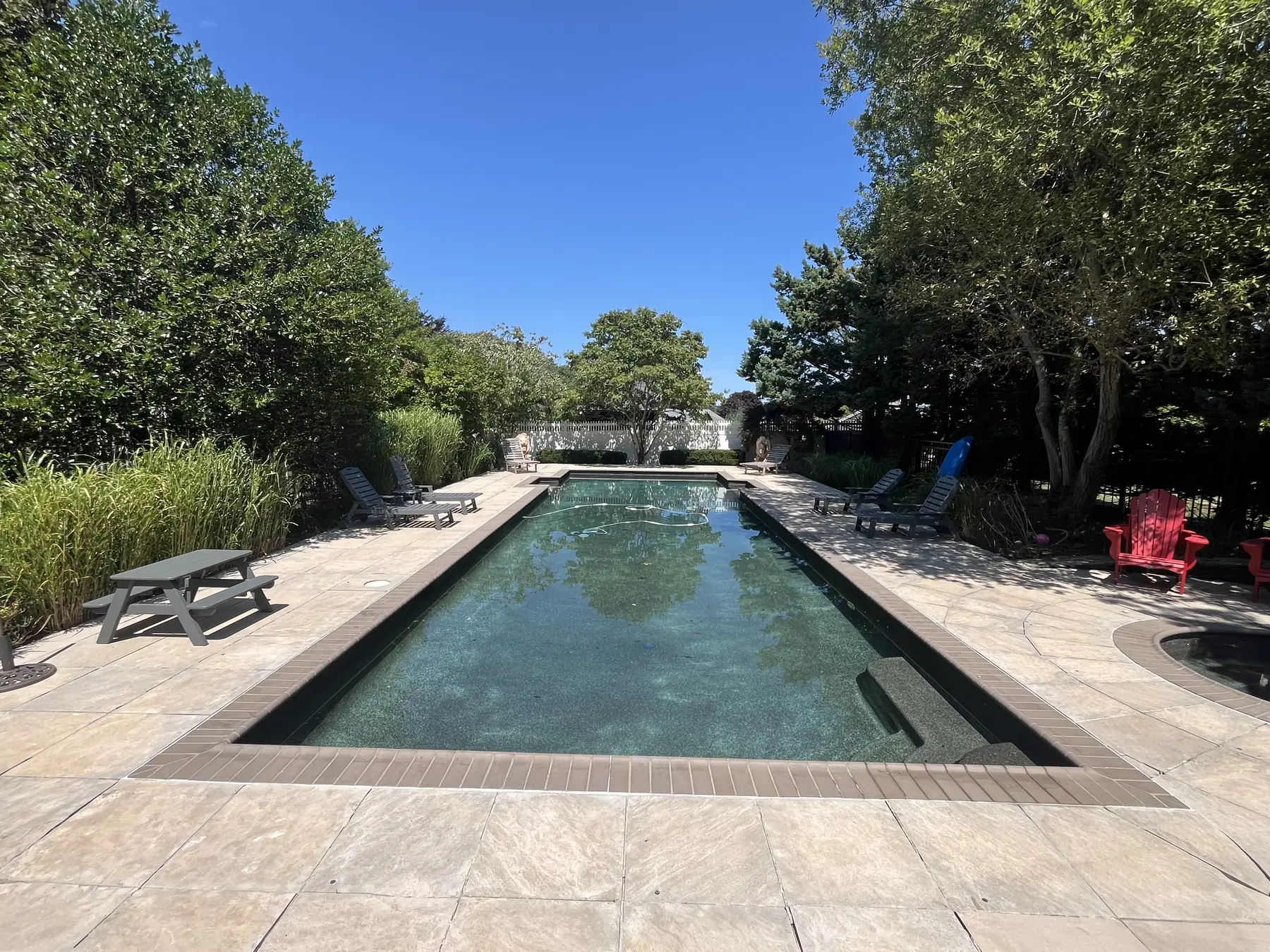 Pool deck cleaning in Plymouth MA, restored pool surround after soft washing and pressure washing by H2WOAH