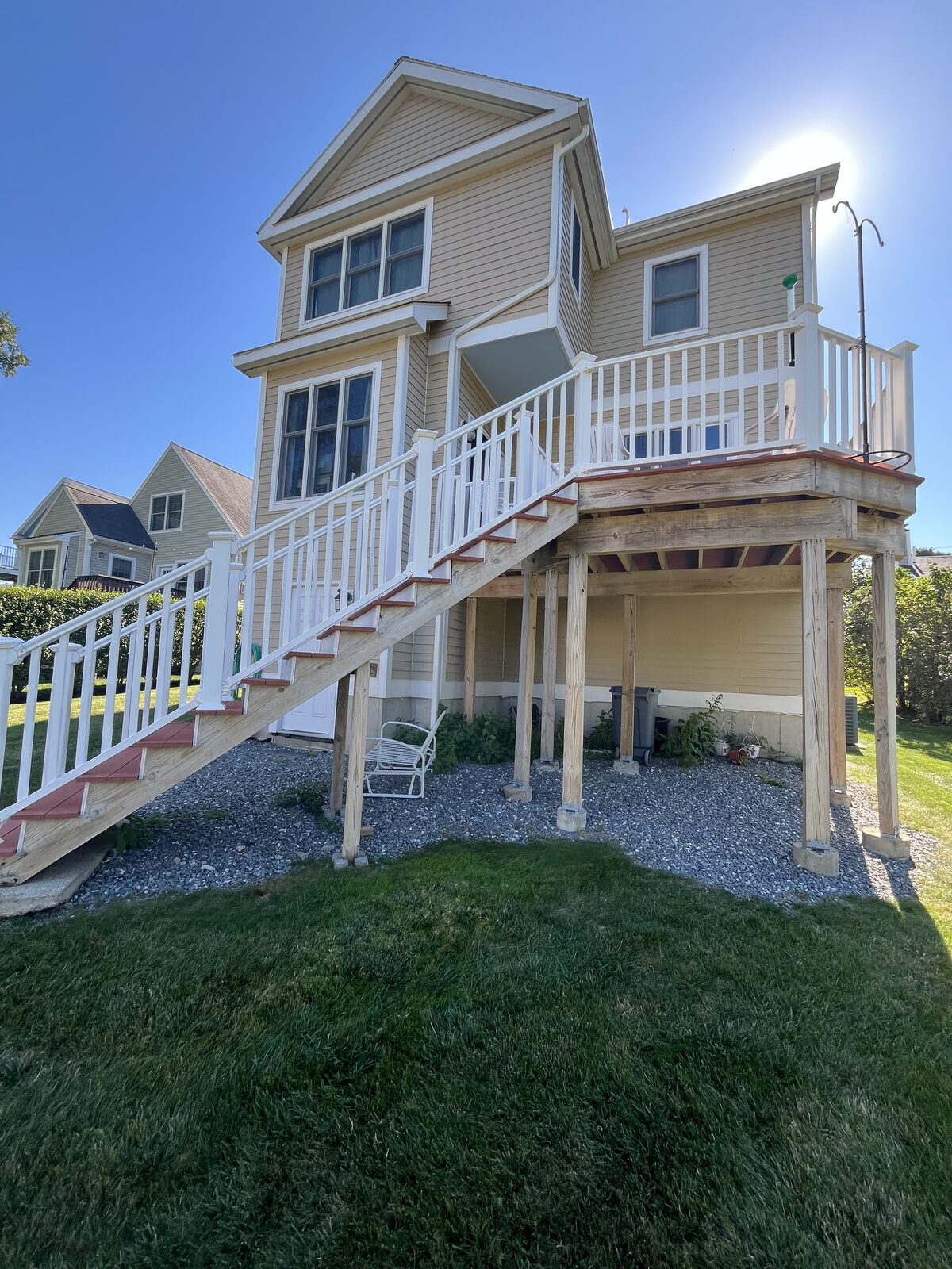 Hingham MA beach property house after washing the raised deck and siding, showing clean bright clapboards with organic buildup and salt residue removed