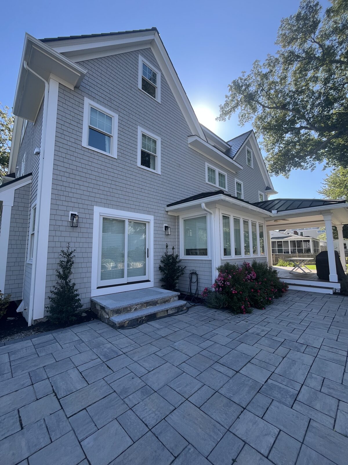 Hingham MA beach house with cedar shingle siding and paver patio after a soft wash, showing clean gray shingles prepped and ready for the summer season
