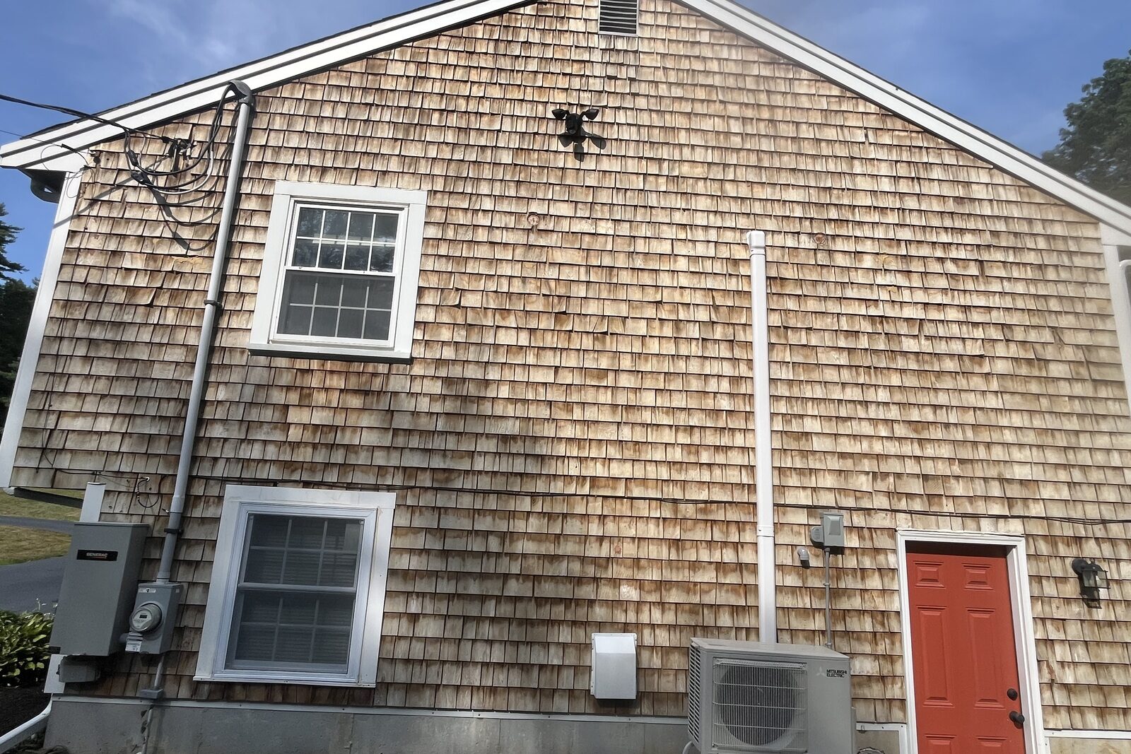 After beach house vinyl wash in Hingham MA by H2WOAH Exterior Cleaning showing clean siding with green buildup and salt residue removed