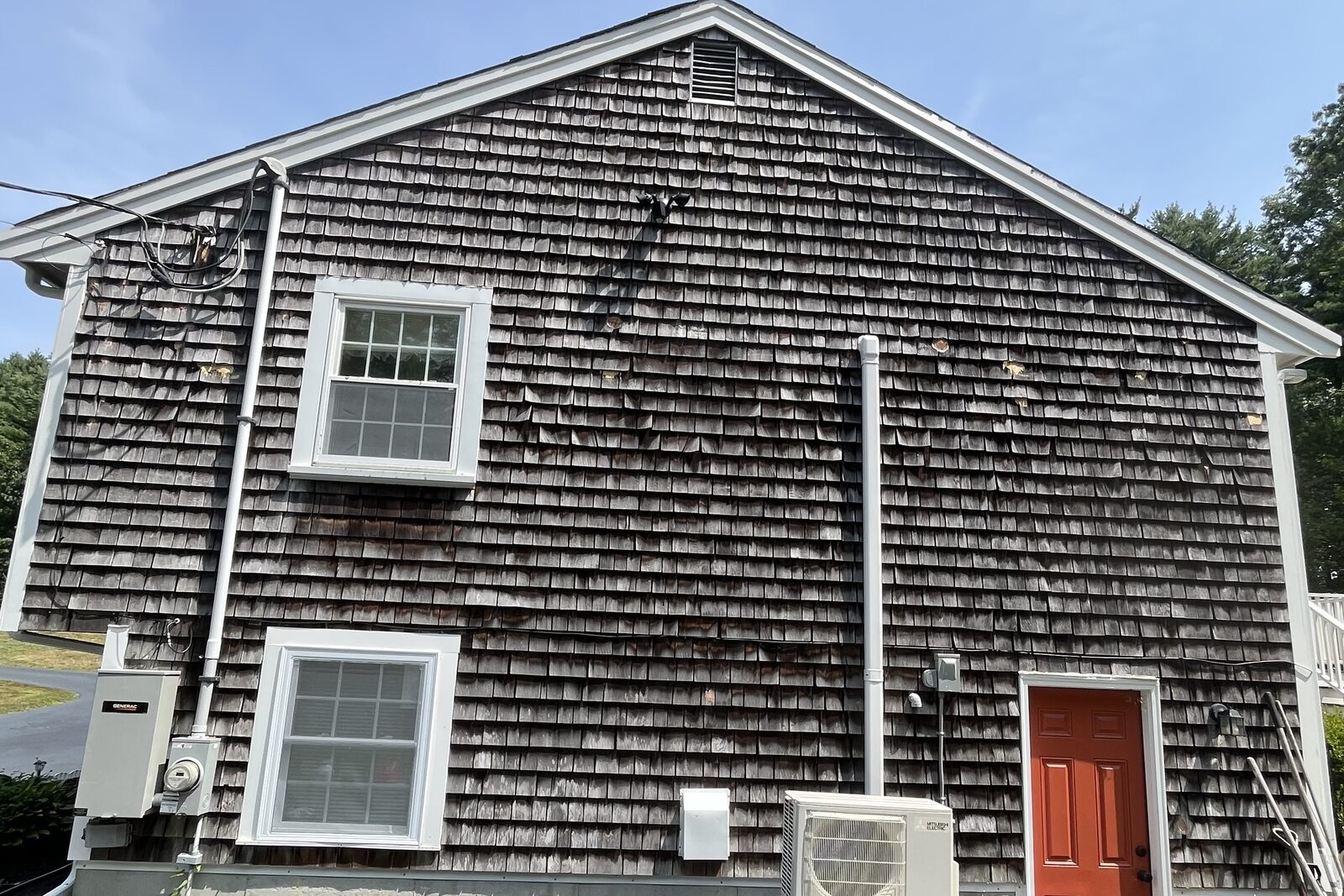 Before house washing in Hingham MA beach house showing green organic buildup and salt residue on the siding