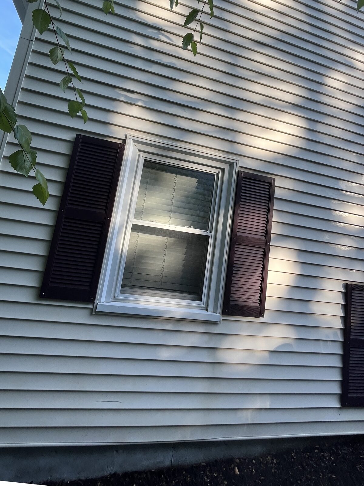 After soft wash house washing in Marshfield MA by H2WOAH Exterior Cleaning showing clean siding restored to its natural look