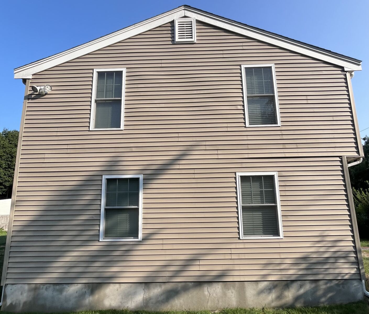 After vinyl siding house wash in Weymouth MA by H2WOAH Exterior Cleaning showing clean uniform siding