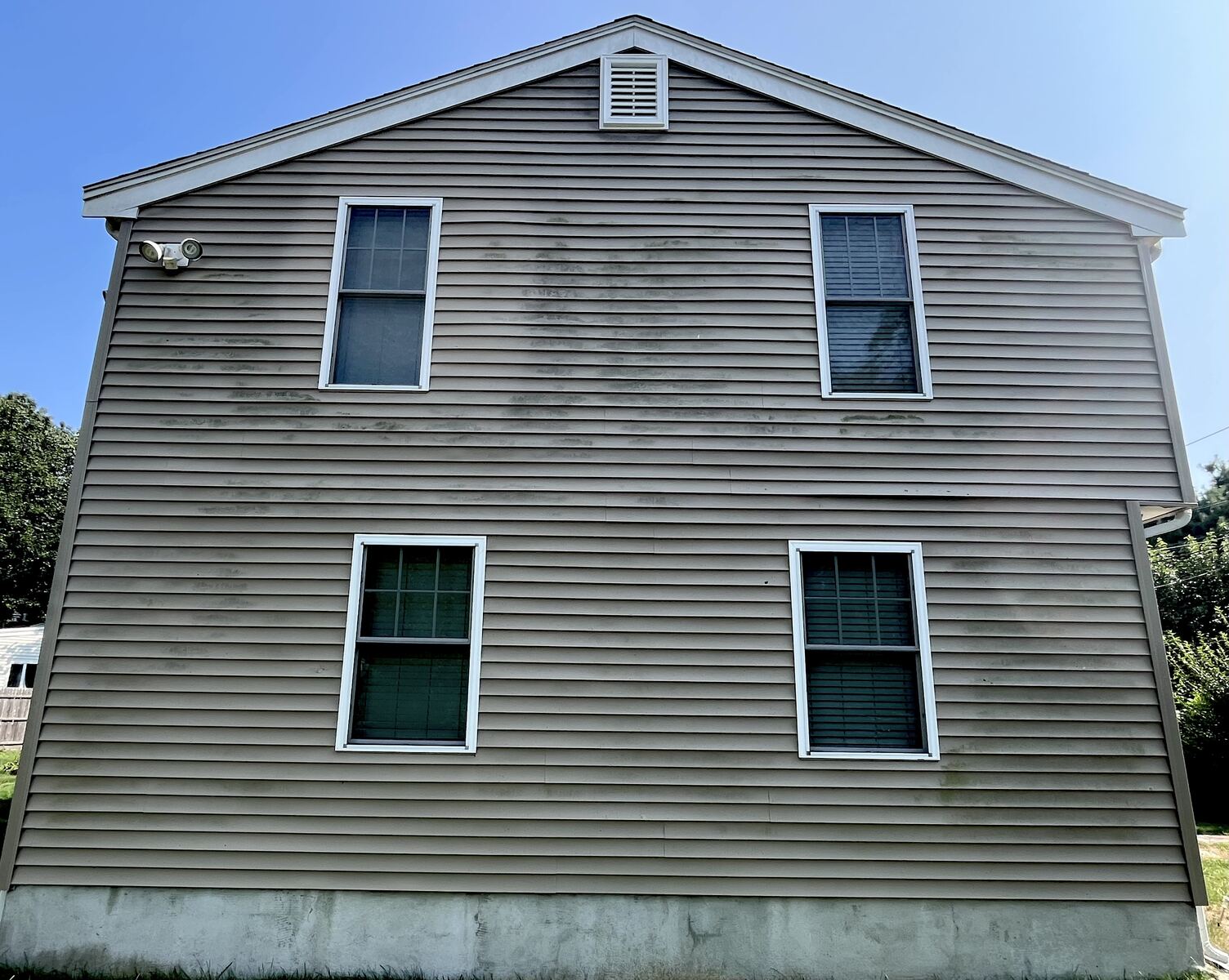 Before vinyl house washing in Weymouth MA showing dark mildew and dirt streaks across siding