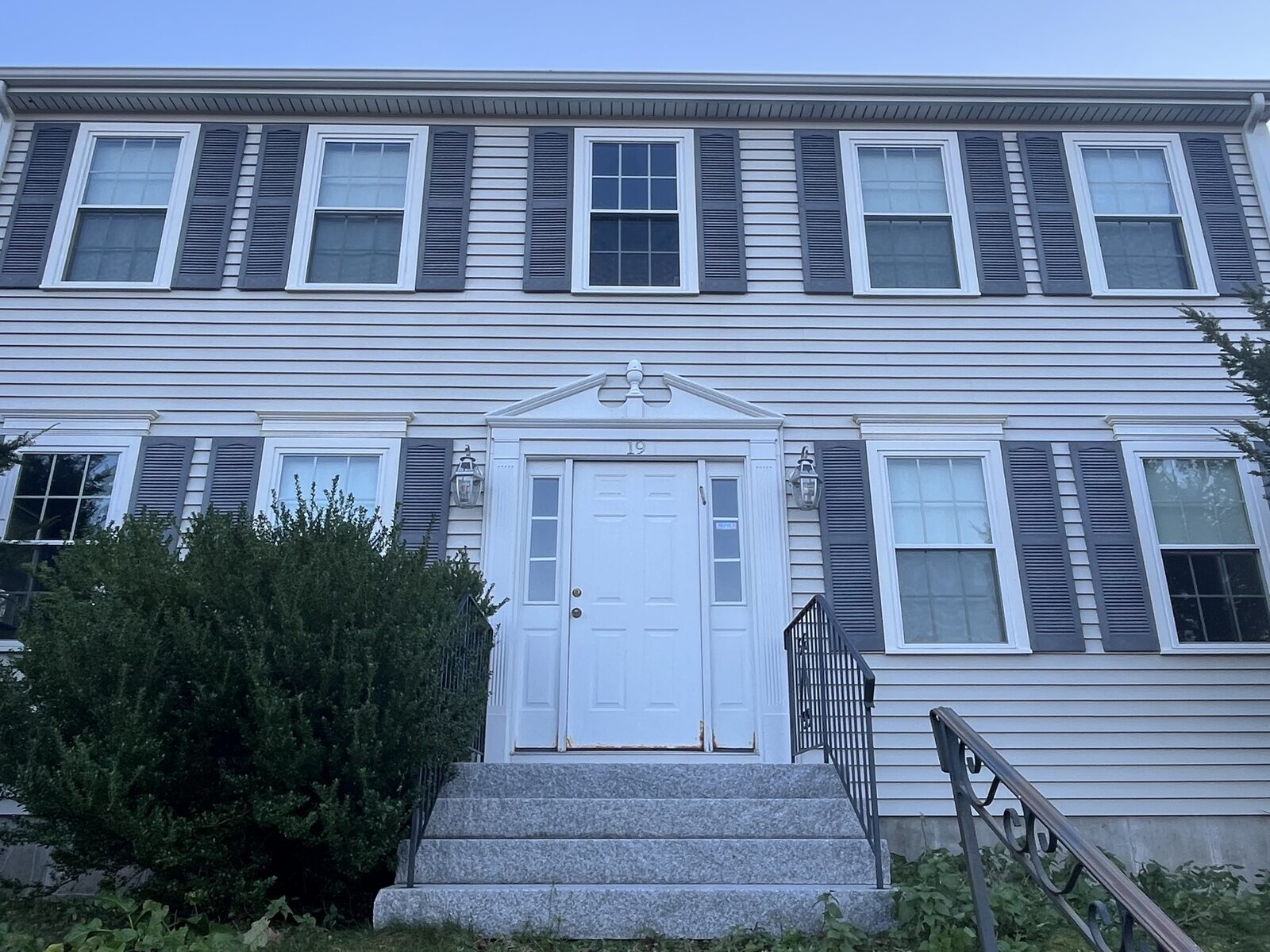 After soft wash house washing in Weymouth MA by H2WOAH Exterior Cleaning showing clean vinyl siding with organic buildup removed