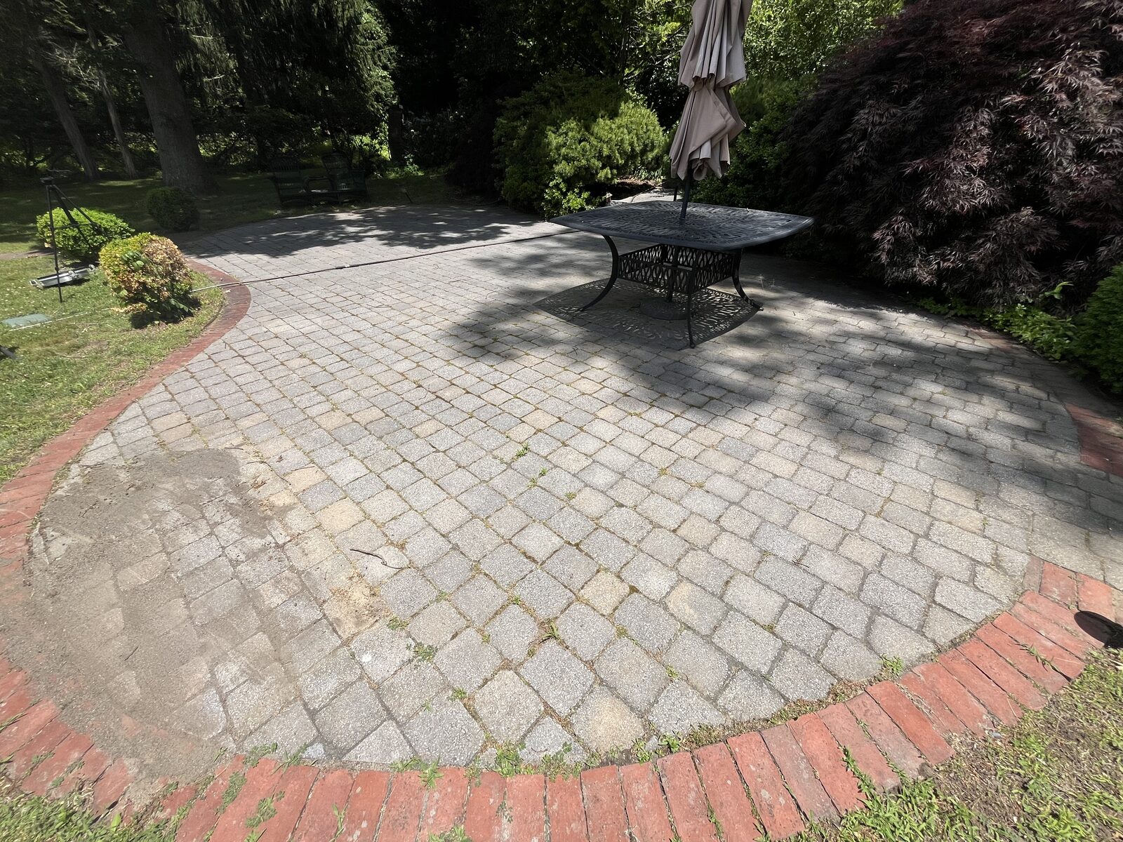 Before paver patio cleaning in Marshfield MA showing dull gray brick pavers stained with dirt and algae
