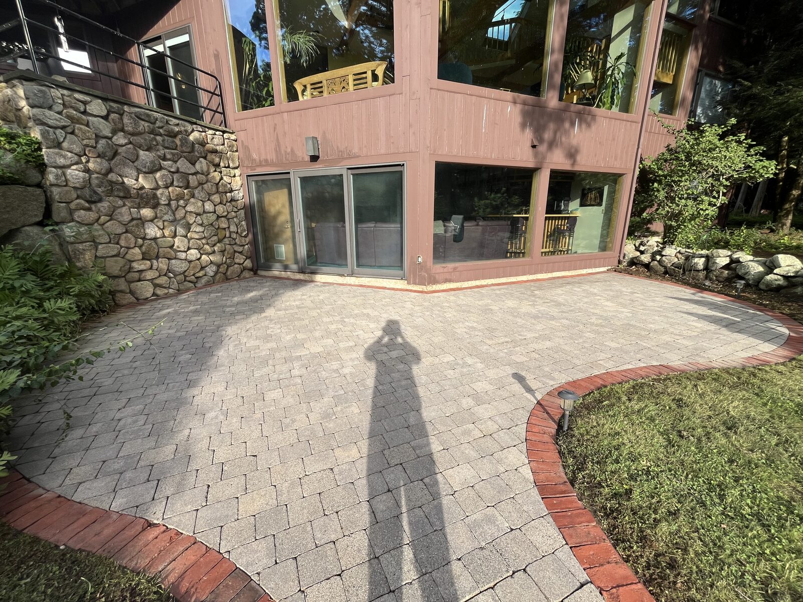 After cobblestone paver patio cleaning in Marshfield MA by H2WOAH Exterior Cleaning showing clean pavers with weeds and moss removed from the joints