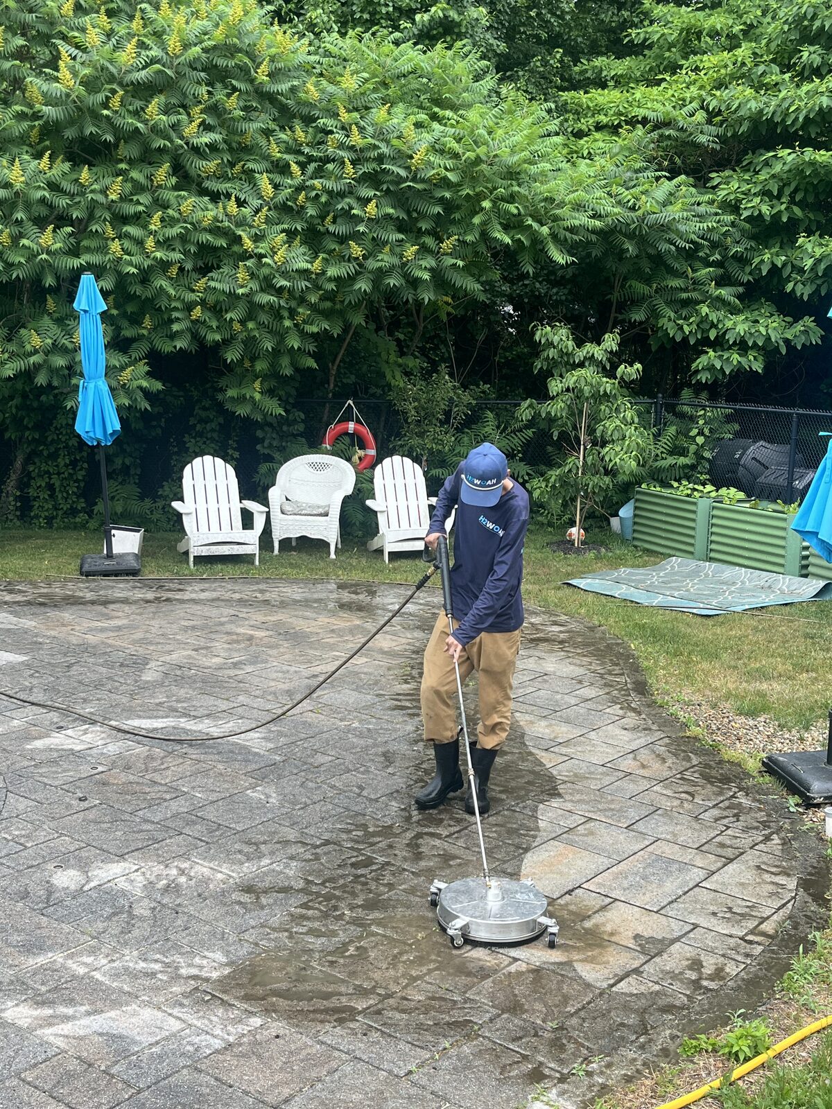 H2WOAH Exterior Cleaning surface cleaning a paver pool patio in Scituate MA during the cleaning process