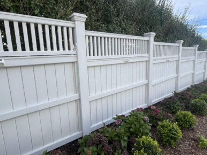 Fence cleaning result — bright white vinyl fence