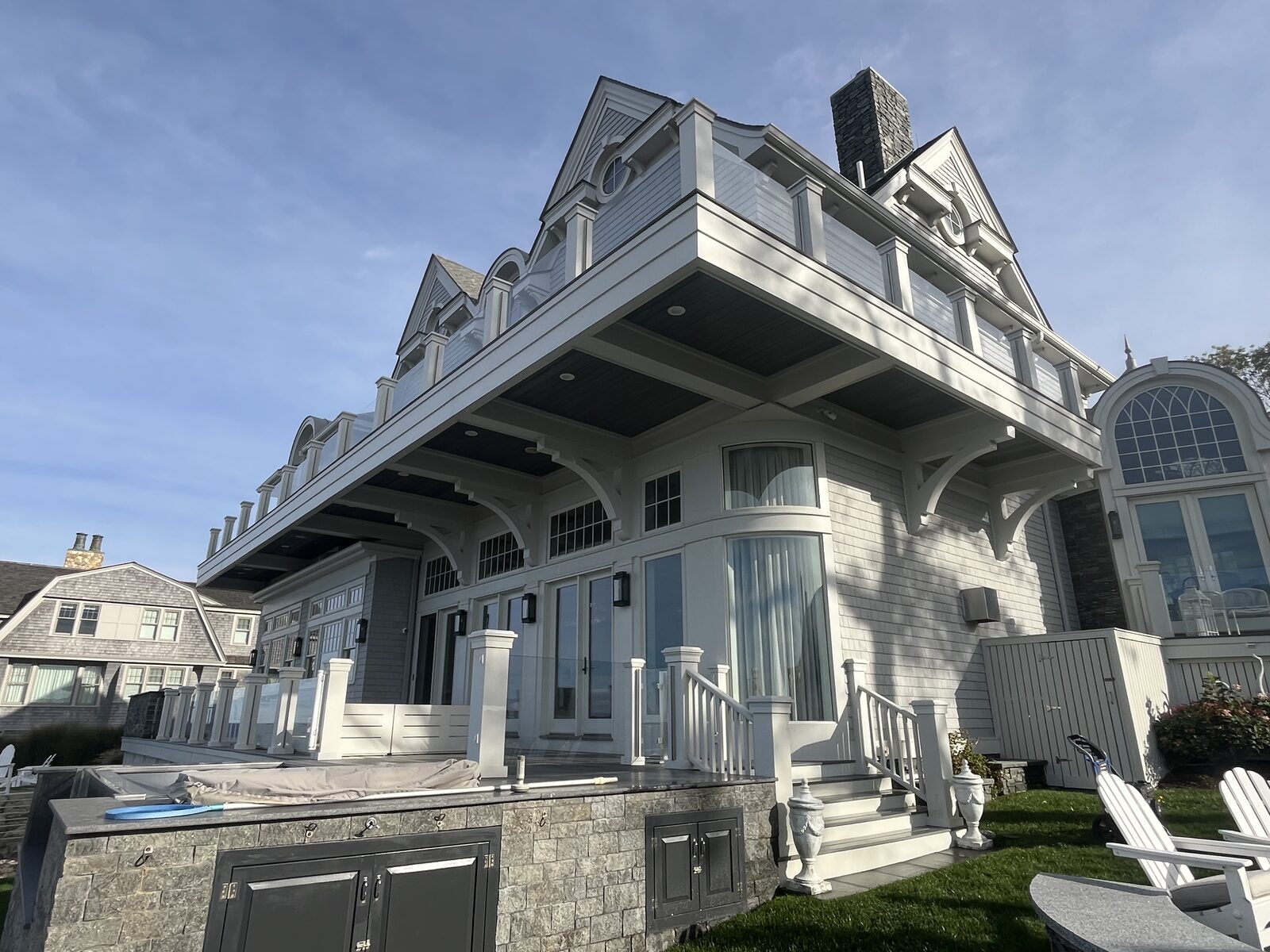Cohasset MA shingle beach home soft washed and prepped for caulking on the trims, sills, and underside of the second-story balcony with spider webbing and organic staining removed